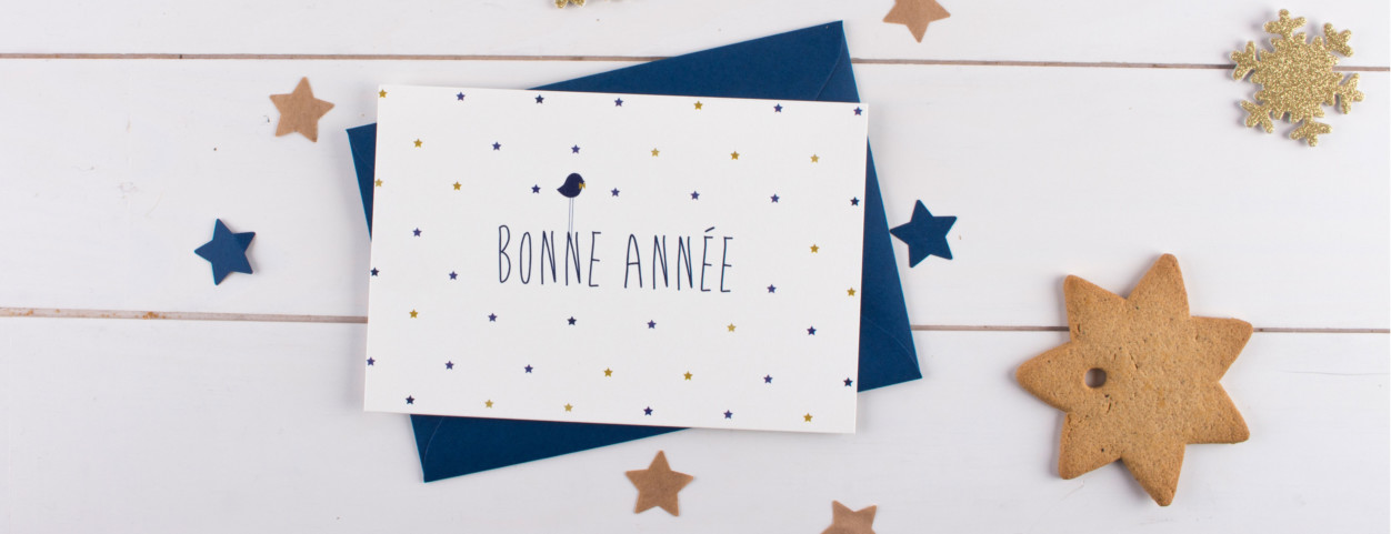 Carte de vœux aux motifs étoilés, un original oiseau perché sur les lettres de "Bonne Année"